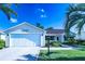 Inviting home with well-kept lawn, charming front porch, and a two-car garage at 1617 Lakewood Dr, The Villages, FL 32162