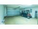 Spacious garage with room for golf cart and overhead door at 1617 Lakewood Dr, The Villages, FL 32162
