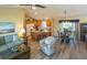 Open-concept living space with hardwood floors, ample seating, and natural light at 1617 Lakewood Dr, The Villages, FL 32162