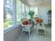 Bright sunroom with wicker furniture, a white rug, and windows with outdoor views at 1617 Lakewood Dr, The Villages, FL 32162