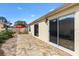 Inviting back patio features a stone surface and sliding glass doors, perfect for indoor-outdoor living at 1622 Valley Falls Way, The Villages, FL 32162