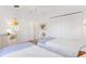 Bright bedroom featuring twin beds, white furniture, and closet at 1622 Valley Falls Way, The Villages, FL 32162