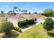 Beautiful single-story home featuring a well-manicured lawn and lush landscaping at 1622 Valley Falls Way, The Villages, FL 32162