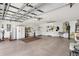 Spacious garage with ample storage, including shelving and a washer and dryer hookup at 1622 Valley Falls Way, The Villages, FL 32162