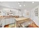 Bright kitchen with white cabinetry, island, and hardwood floors with an open floor plan at 1622 Valley Falls Way, The Villages, FL 32162
