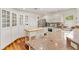 Cozy kitchen featuring white cabinetry, granite countertops, and stainless steel appliances at 1622 Valley Falls Way, The Villages, FL 32162