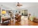 Living room area featuring a ceiling fan, hardwood floors, sliding glass doors, and comfortable seating at 1622 Valley Falls Way, The Villages, FL 32162