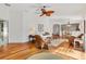 Bright living room featuring hardwood floors, ceiling fan, and comfortable seating at 1622 Valley Falls Way, The Villages, FL 32162