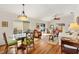 Cozy dining room and living room area with hardwood floors and lots of natural light at 1622 Valley Falls Way, The Villages, FL 32162