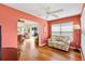 Inviting living room boasts hardwood floors, a ceiling fan, and a bright window with a cozy floral sofa at 1622 Valley Falls Way, The Villages, FL 32162