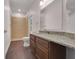 Granite counters accent this bathroom with a step-in shower and dark wood floors at 16611 Spring Park Dr, Clermont, FL 34711