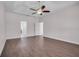 Bright bedroom with wood-look flooring, ceiling fan, and an open doorway to a hall with the attached bathroom at 16611 Spring Park Dr, Clermont, FL 34711