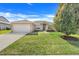 Well-maintained front yard and a two car garage create excellent curb appeal at 16611 Spring Park Dr, Clermont, FL 34711