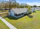 Aerial view of the backyard featuring a screened in lanai and lush lawn at 1676 E Spring Ridge Cir, Winter Garden, FL 34787