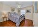 Bedroom featuring hardwood floors, neutral paint, a ceiling fan, and a window at 16865 Se 94Th Sunnybrook Cir, The Villages, FL 32162