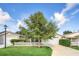 Charming single-story home featuring a well-manicured lawn, mature tree, and a classic white picket fence at 16865 Se 94Th Sunnybrook Cir, The Villages, FL 32162