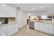 Kitchen features stainless appliances, white cabinets, quartz counters, and an open view into a dining area at 16865 Se 94Th Sunnybrook Cir, The Villages, FL 32162