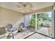 Enclosed Lanai with tile flooring and ceiling fan with 2 chairs at 16865 Se 94Th Sunnybrook Cir, The Villages, FL 32162