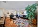Open-concept living room with hardwood floors and view of the kitchen at 16865 Se 94Th Sunnybrook Cir, The Villages, FL 32162