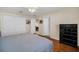 Bedroom featuring hardwood floors, white trim, and a closet at 16865 Se 94Th Sunnybrook Cir, The Villages, FL 32162