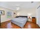 Comfortable main bedroom features a ceiling fan, hardwood floors, and neutral paint at 16865 Se 94Th Sunnybrook Cir, The Villages, FL 32162