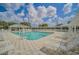Resort-style pool with a pergola, lounge chairs, and lush landscaping offers a relaxing outdoor space for residents at 16865 Se 94Th Sunnybrook Cir, The Villages, FL 32162