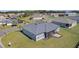 Aerial view of a modern home with a screened-in porch, situated on a well-manicured lawn at 17204 Se 112Th Court Rd, Summerfield, FL 34491