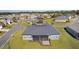 Aerial view of a residential home in a neighborhood featuring a screened-in porch and green lawn at 17204 Se 112Th Court Rd, Summerfield, FL 34491