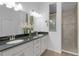Bathroom with double vanity, granite countertop and step in shower with decorative tile accents at 17204 Se 112Th Court Rd, Summerfield, FL 34491