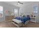 Comfortable bedroom featuring many windows, a ceiling fan, and light hardwood flooring at 17204 Se 112Th Court Rd, Summerfield, FL 34491