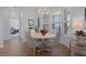 Cozy dining area with bay windows, hardwood floors, and stylish chandelier at 17204 Se 112Th Court Rd, Summerfield, FL 34491