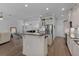 Bright eat-in kitchen featuring a center island, stainless steel appliances, and hardwood floors at 17204 Se 112Th Court Rd, Summerfield, FL 34491