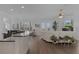 Open floor plan features living room with fireplace open to kitchen with bar top seating at 17204 Se 112Th Court Rd, Summerfield, FL 34491
