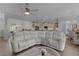 Spacious living room with open layout, hardwood floors, and comfortable sectional sofa at 17204 Se 112Th Court Rd, Summerfield, FL 34491