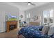 Bright main bedroom featuring plantation shutters, hardwood floors, and a ceiling fan at 17204 Se 112Th Court Rd, Summerfield, FL 34491