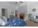 Spacious main bedroom featuring hardwood floors, a ceiling fan, and an ensuite bath at 17204 Se 112Th Court Rd, Summerfield, FL 34491