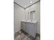 Bathroom featuring a double sink vanity with two mirrors and dark wood-look flooring at 17442 Eve Dr, Montverde, FL 34756
