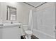 Bright bathroom with a modern vanity, mirror, toilet, and shower/tub combo with white shower curtain at 17442 Eve Dr, Montverde, FL 34756