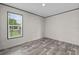 This room features a modern wood-look floor and a bright window with natural light at 17442 Eve Dr, Montverde, FL 34756