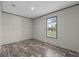 A quiet bedroom featuring wood-look floors and a window for natural light at 17442 Eve Dr, Montverde, FL 34756