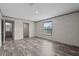 A light-filled bedroom featuring wood-look flooring and an attached bathroom at 17442 Eve Dr, Montverde, FL 34756