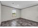 Cozy bedroom featuring dark wood-look floors and a large window at 17442 Eve Dr, Montverde, FL 34756