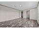 An airy bedroom features a light gray interior with wood-look flooring and multiple doors at 17442 Eve Dr, Montverde, FL 34756