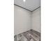 A small closet features dark wood-look flooring with a single shelf for storage at 17442 Eve Dr, Montverde, FL 34756