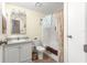 Bathroom features a tub and shower, framed mirror and built-in sink at 1854 W Schwartz Blvd, Lady Lake, FL 32159
