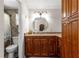 Bathroom features wood cabinets, granite countertops, and a tiled walk-in shower at 1854 W Schwartz Blvd, Lady Lake, FL 32159