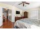 Comfortable bedroom with wood floors and a ceiling fan at 1854 W Schwartz Blvd, Lady Lake, FL 32159