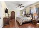 Bedroom featuring a ceiling fan, dresser and a cozy atmosphere at 1854 W Schwartz Blvd, Lady Lake, FL 32159