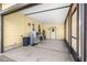 Carport features concrete floors, yellow walls, and access to a side door at 1854 W Schwartz Blvd, Lady Lake, FL 32159