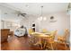 Welcoming dining area with wood floors, fan, and view into the living area at 1854 W Schwartz Blvd, Lady Lake, FL 32159